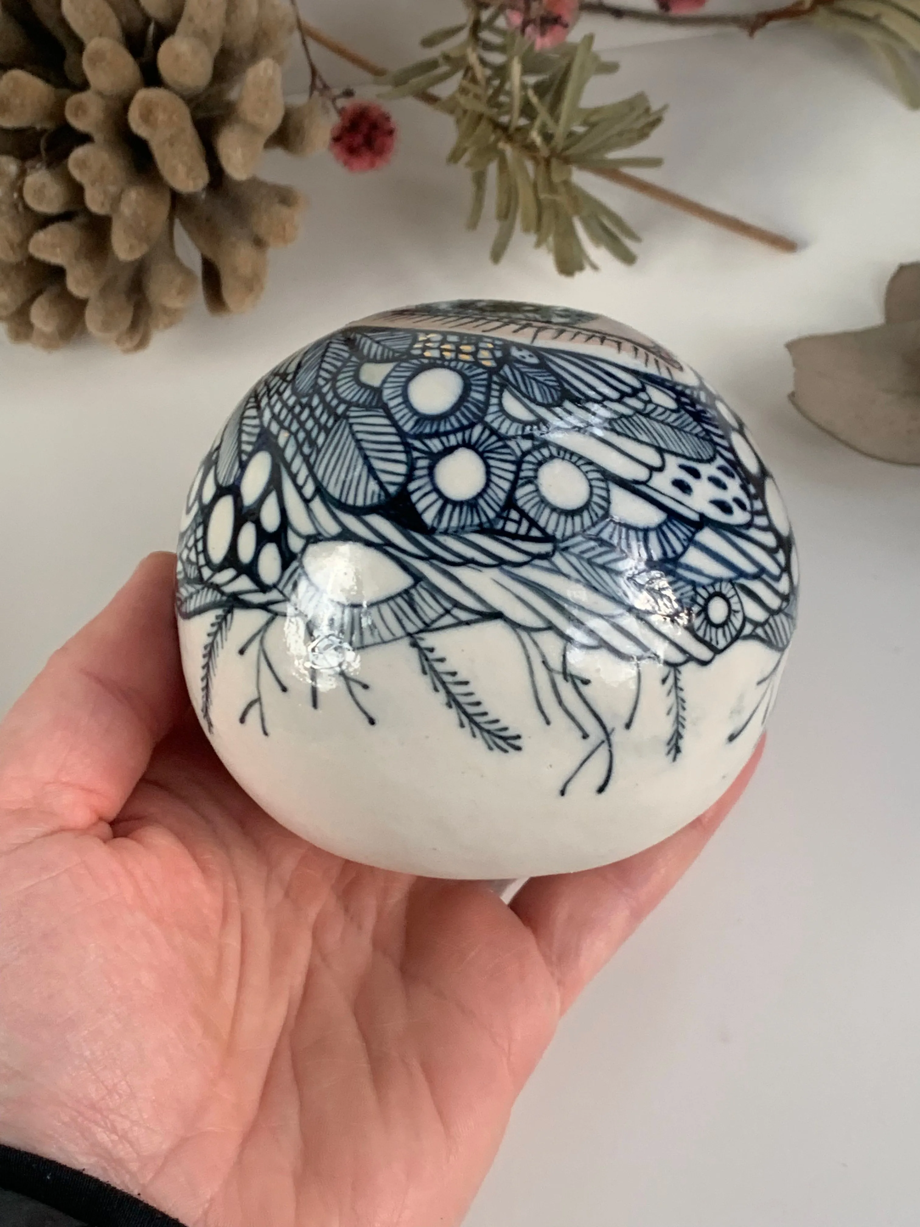 Hand painted porcelain paperweight with gold lustre details